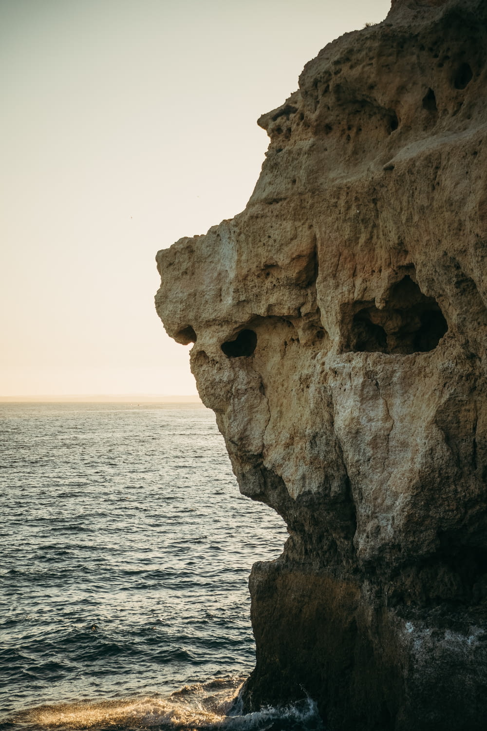 a rock formation on the edge of the ocean