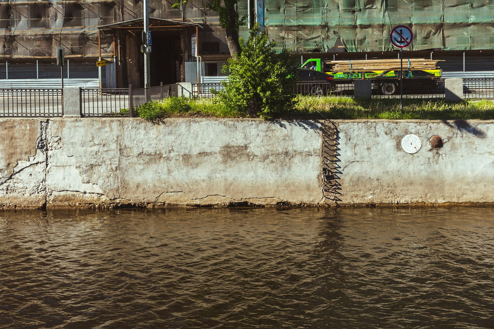 a concrete wall next to a body of water