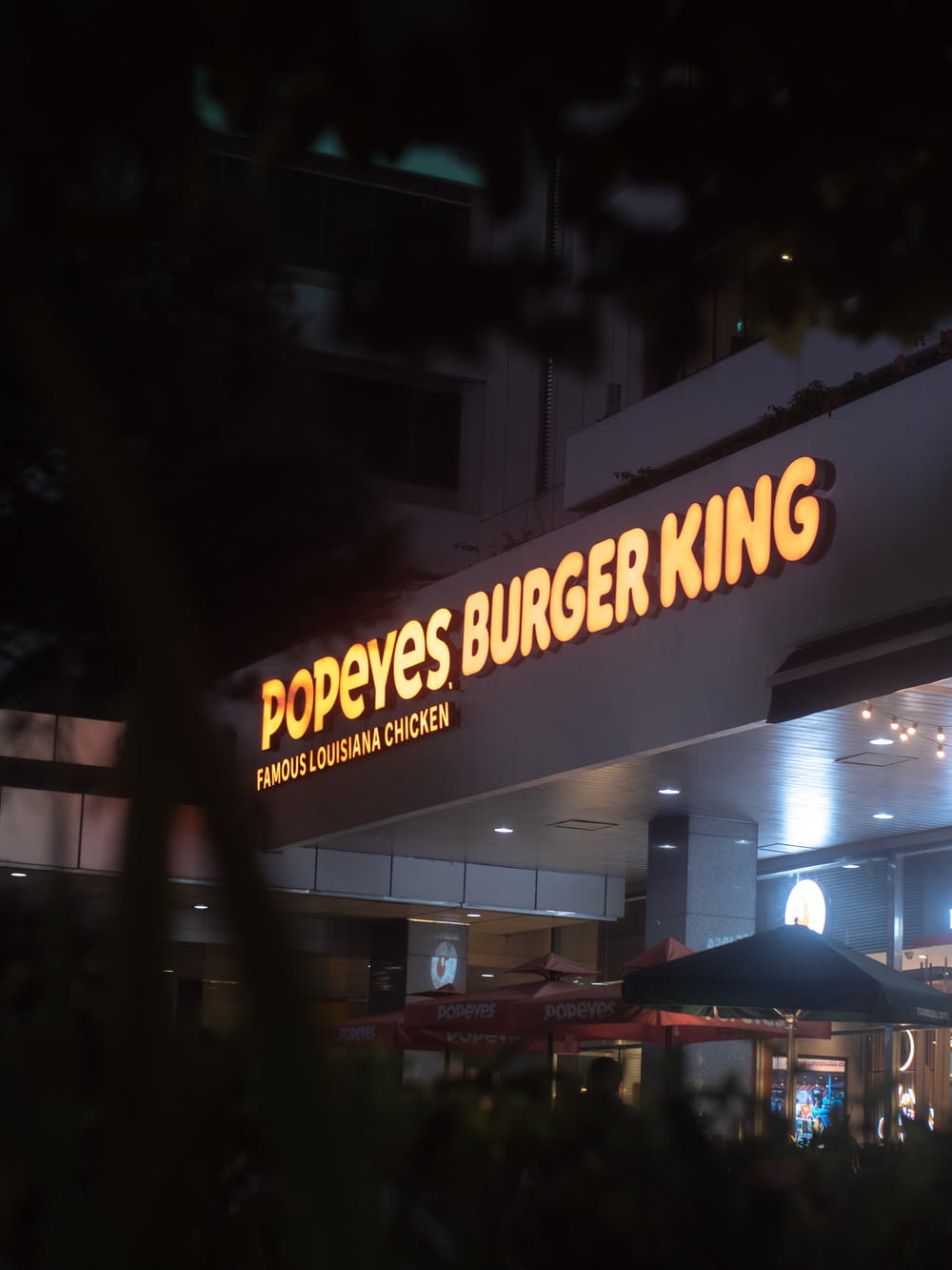 a burger king sign is lit up at night