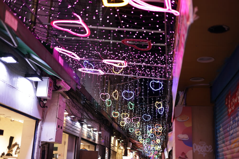 a street with a lot of lights hanging from the ceiling
