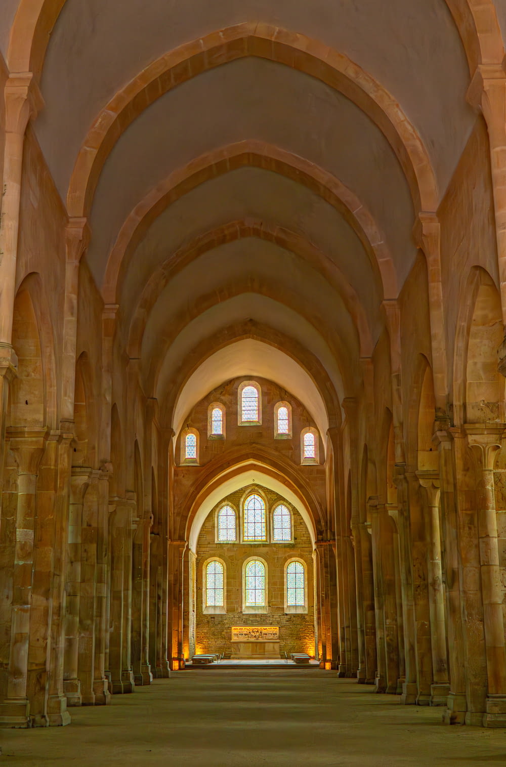 a large cathedral with stone columns and arches