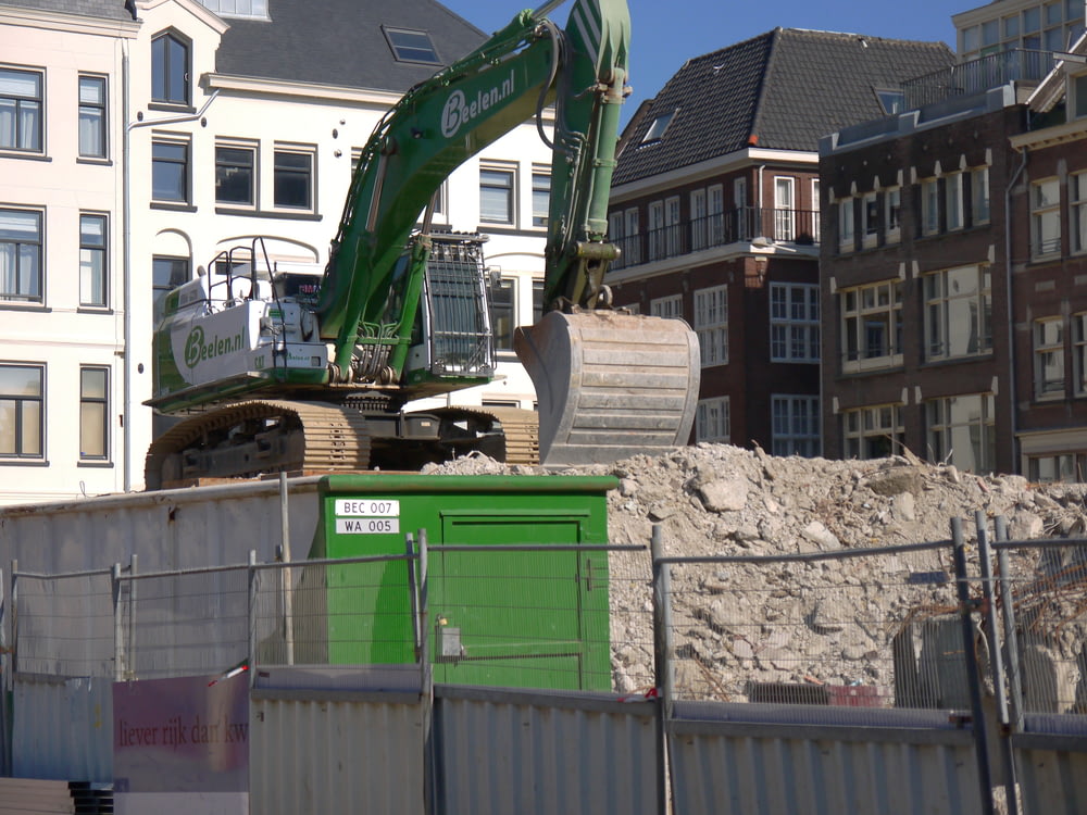 a construction site with a green dump truck