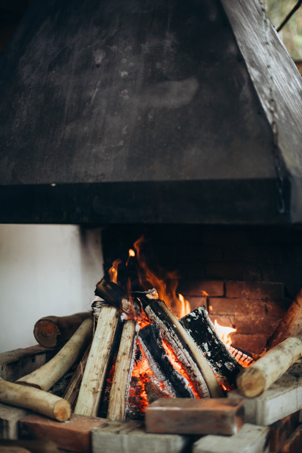a fire is burning in a fireplace with logs