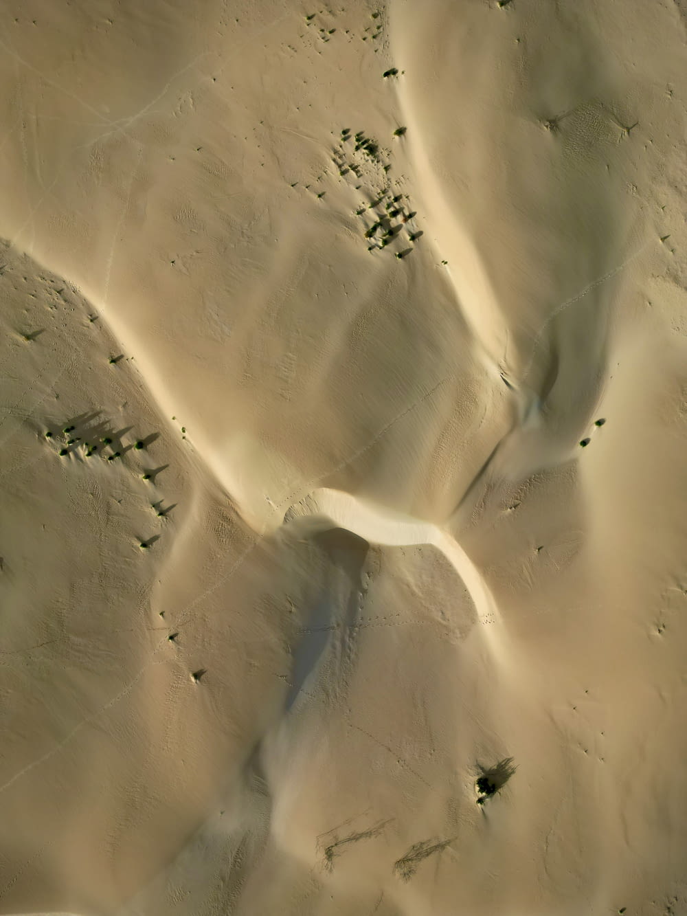 an aerial view of a desert with sand dunes