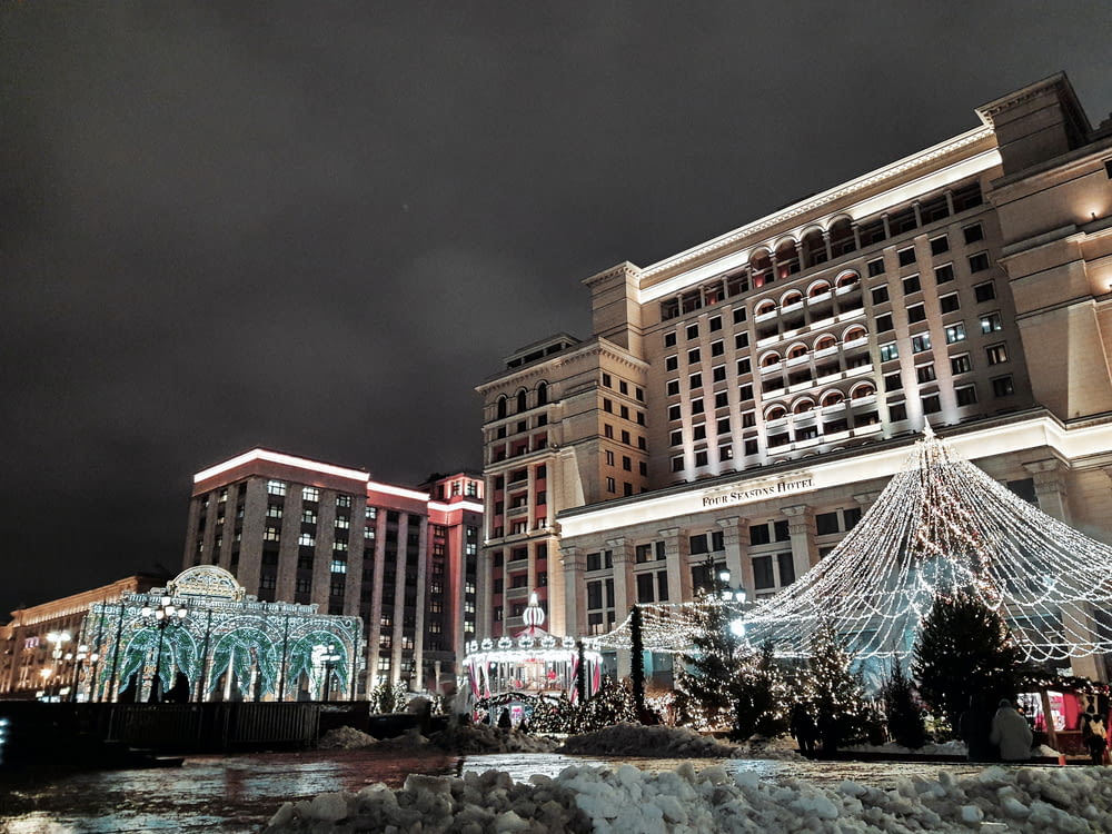 a large building with a christmas tree in front of it
