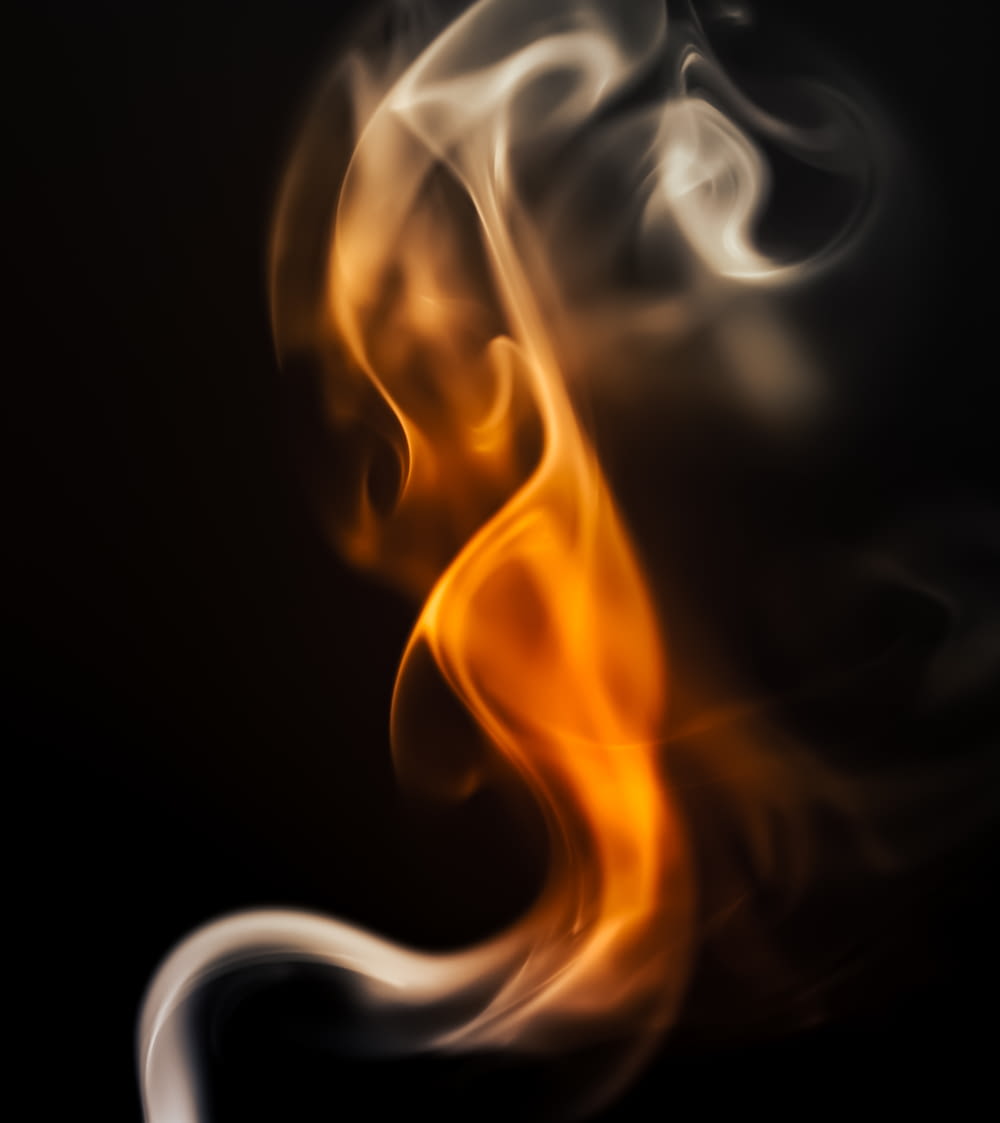 a blurry photo of a fire on a black background