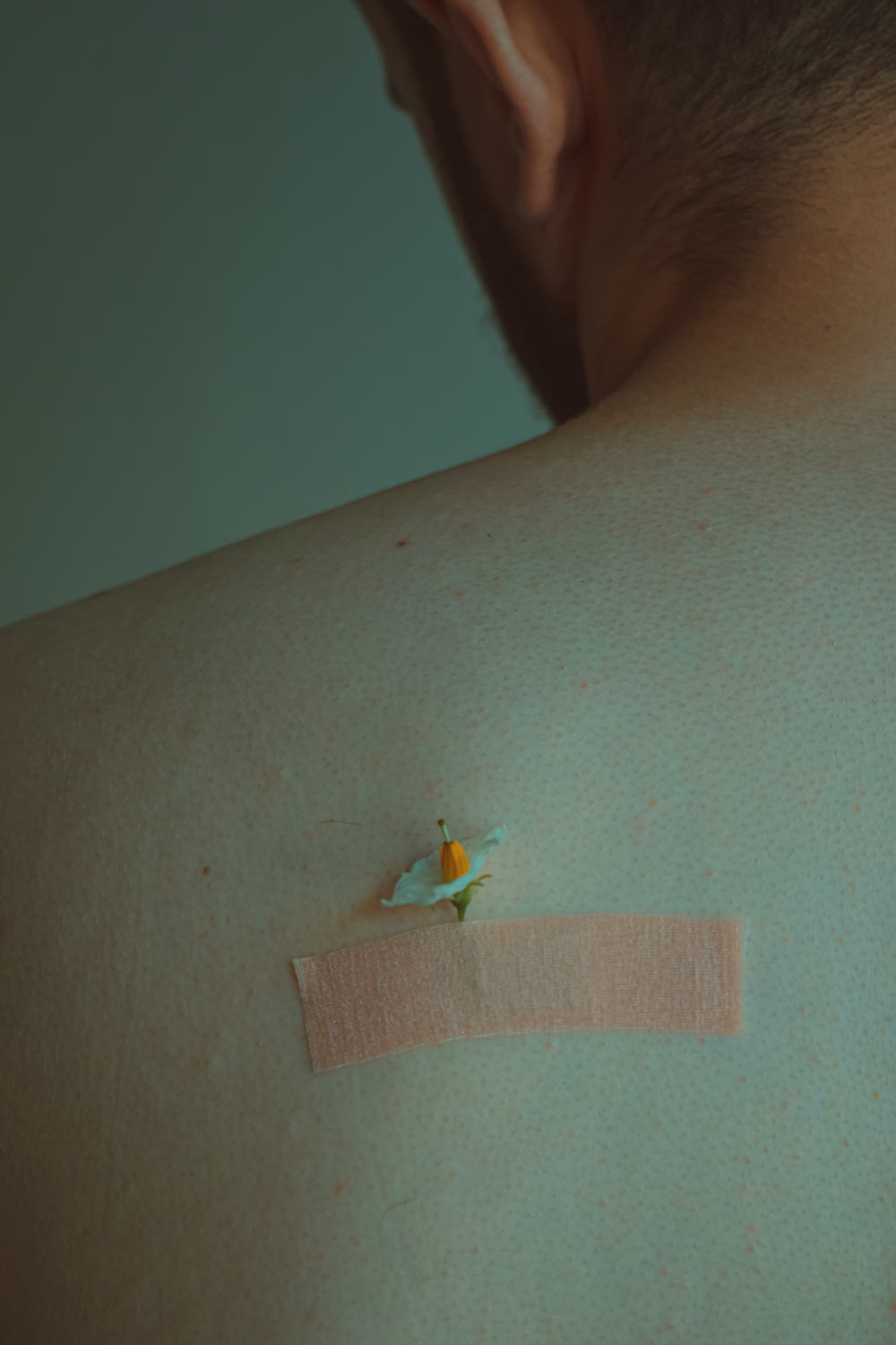 a man with a patch on his back with a flower on it