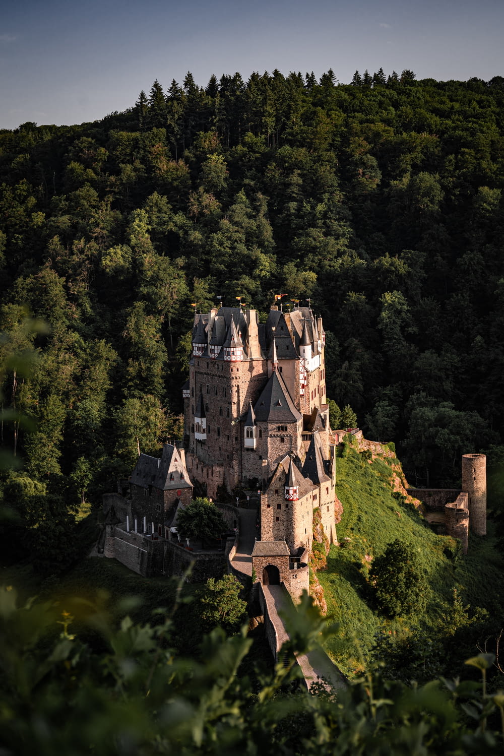 an aerial view of a castle in the middle of a forest