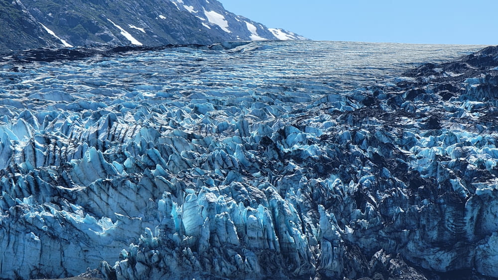a large glacier with lots of blue ice