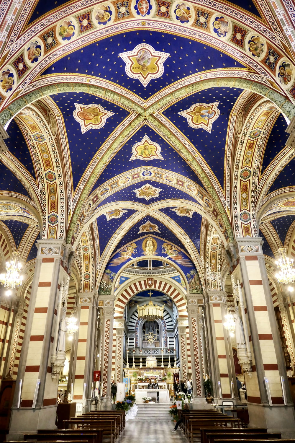 a church with a blue and gold ceiling and a chandelier