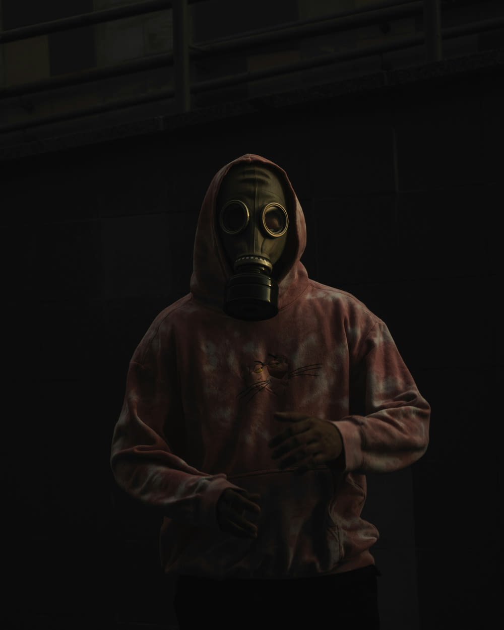 a man in a gas mask holding a cigarette