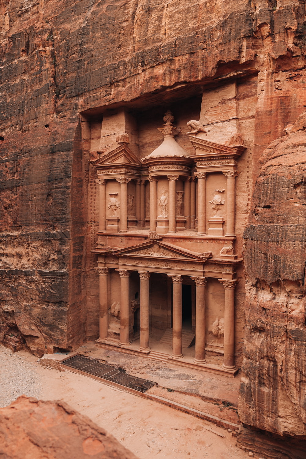a building carved into the side of a cliff