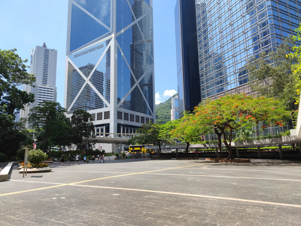 an empty parking lot in a city with tall buildings in the background