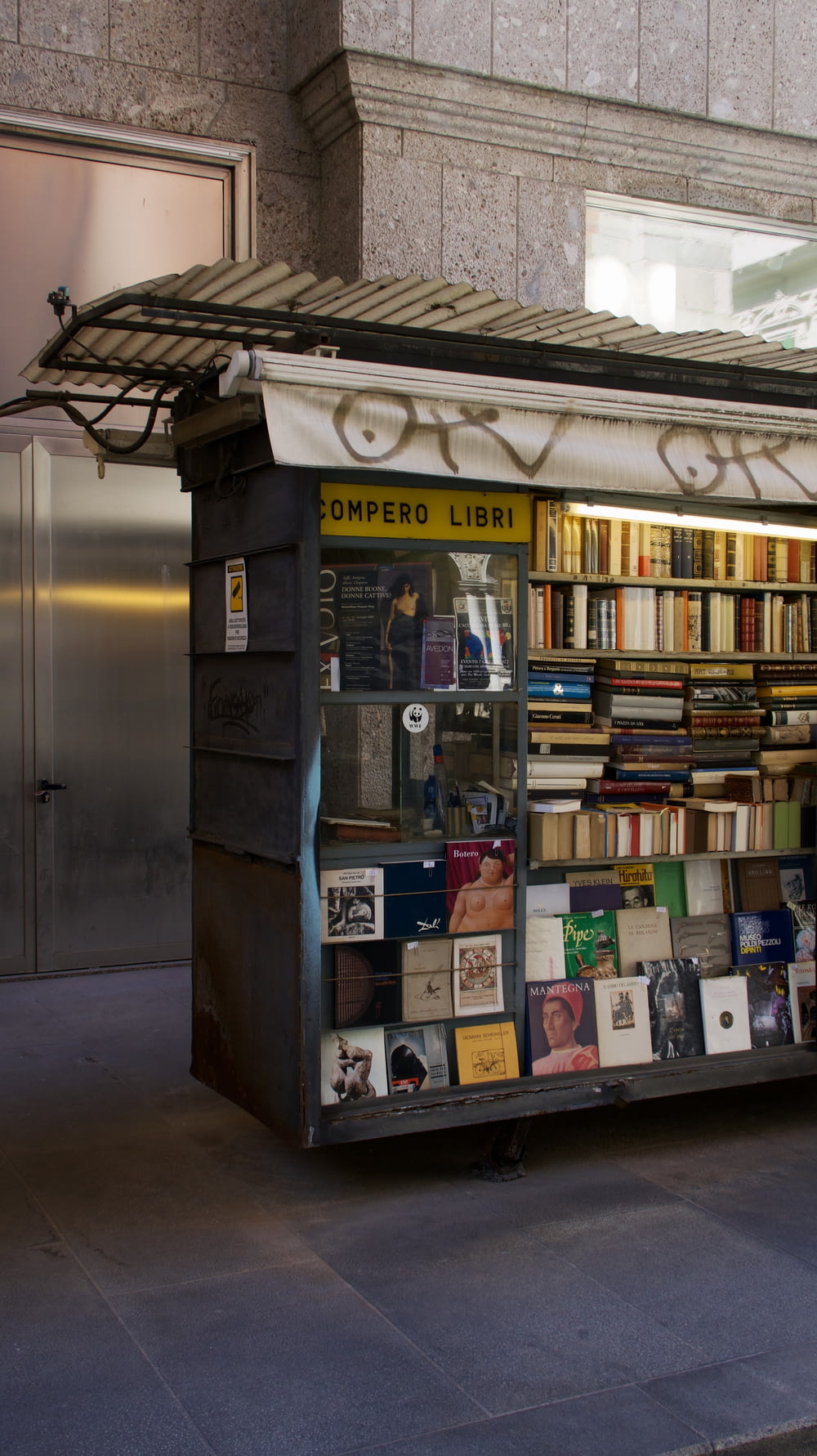 a book stand on the side of a street