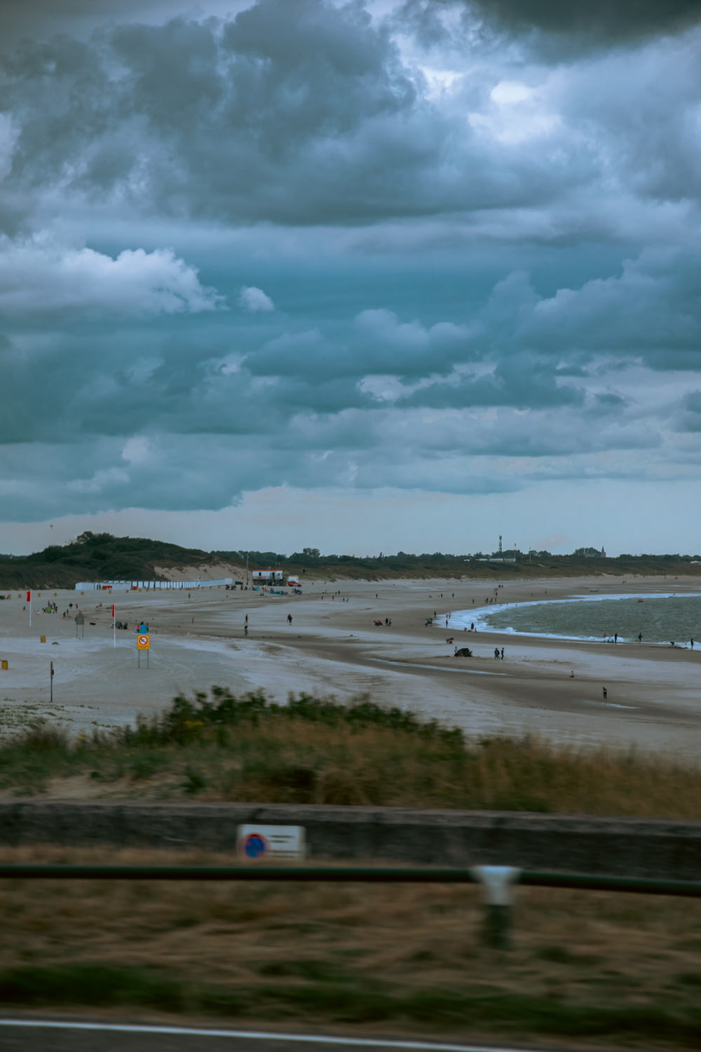 a view of a beach from a moving car
