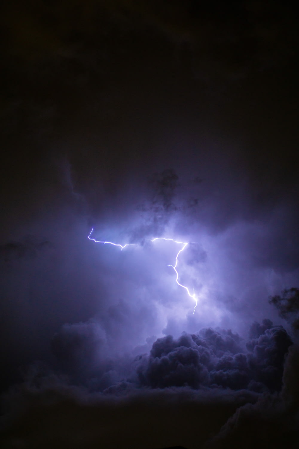 a lightning bolt hitting through a cloudy sky