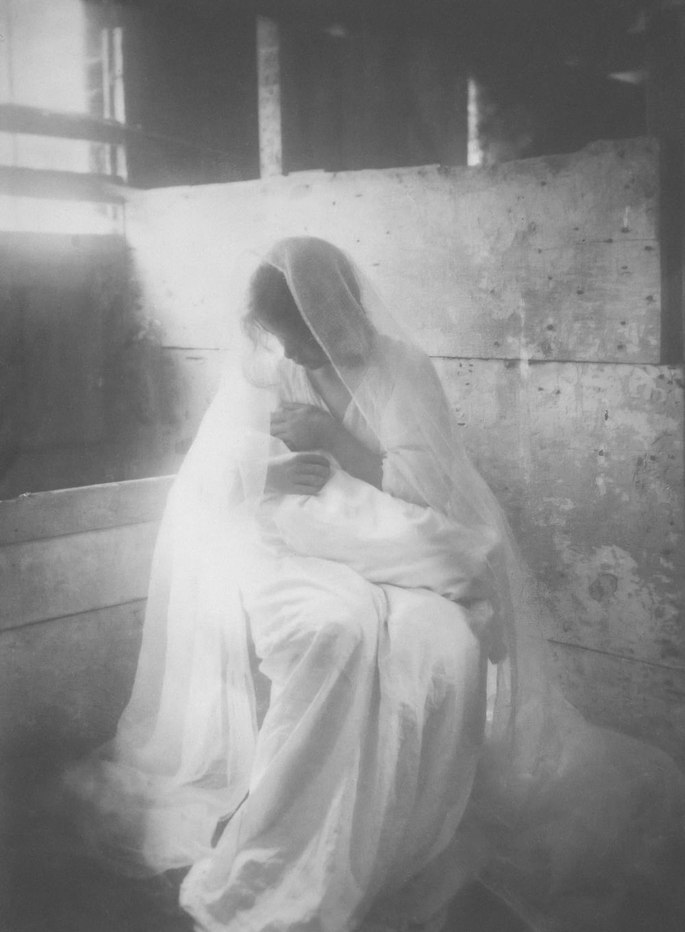 a black and white photo of a woman in a veil