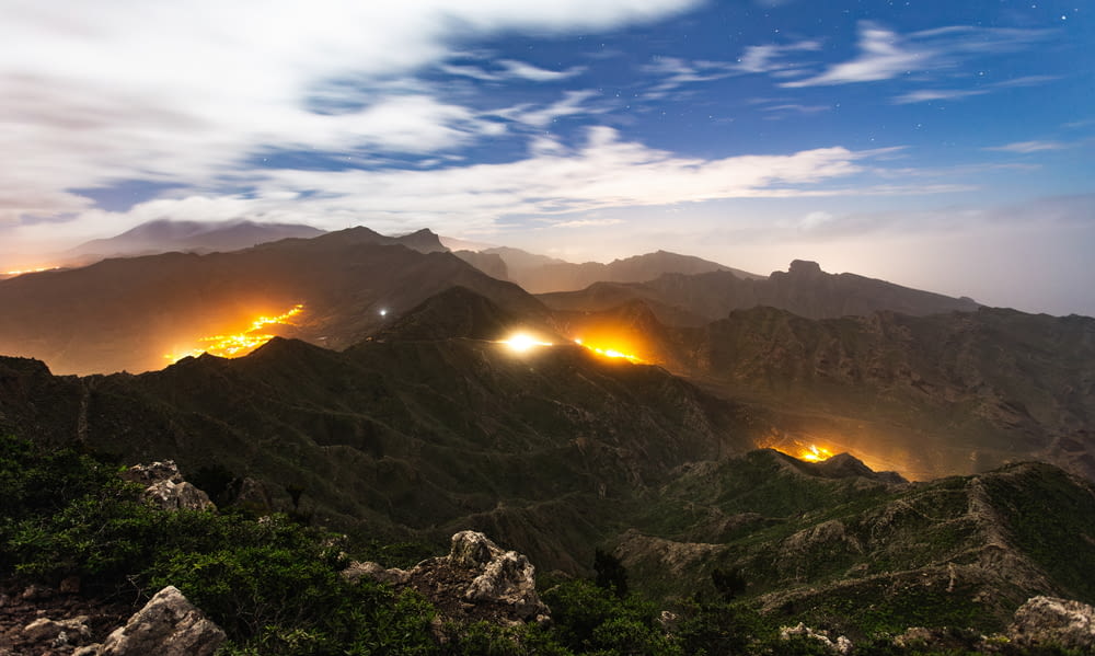 a night view of a mountain range with lights on