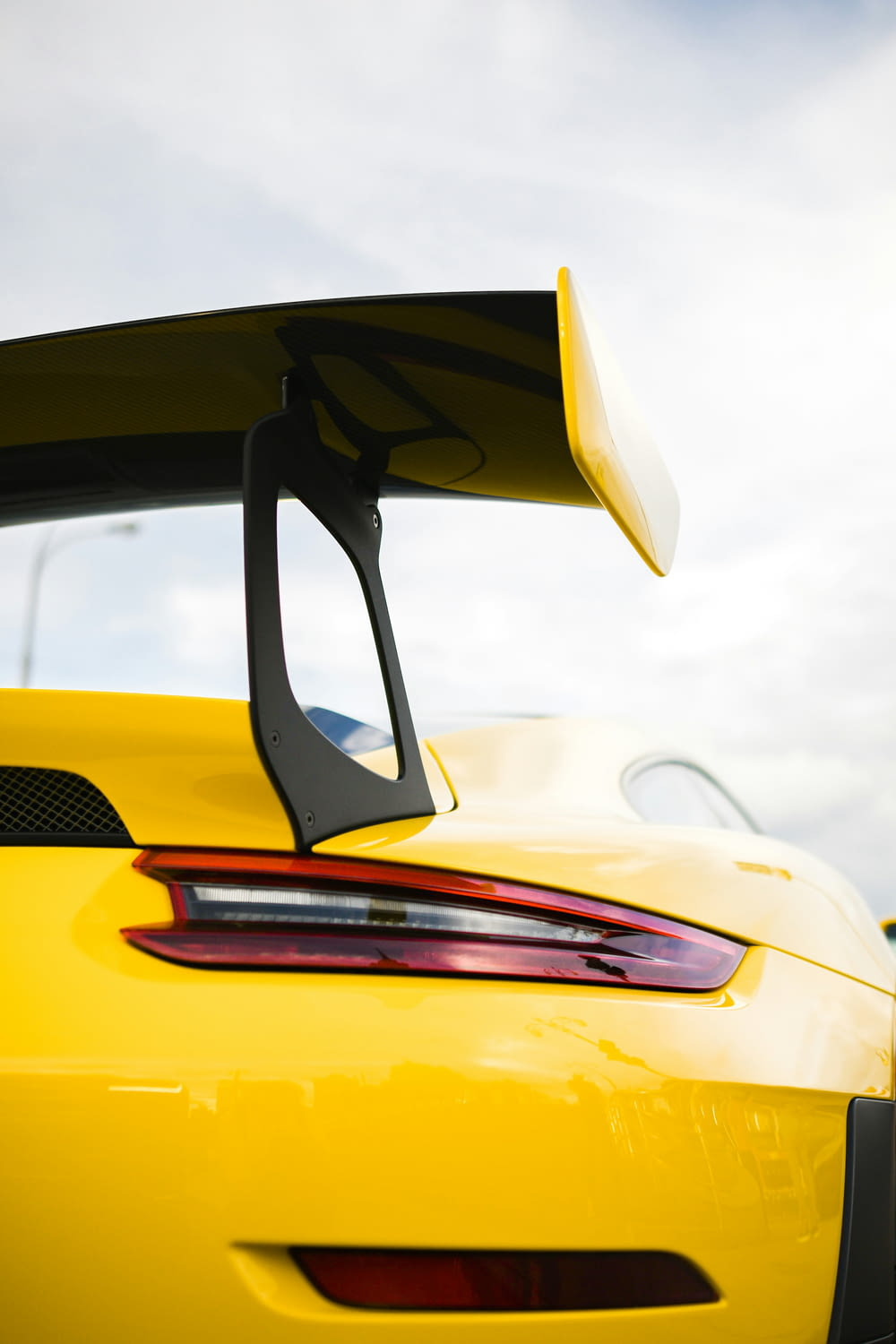 the rear end of a yellow sports car