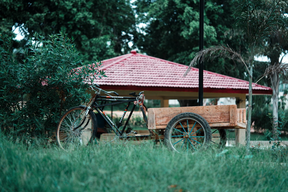 a bike parked next to a wooden cart