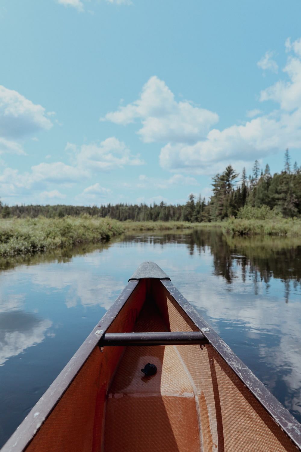 a person in a canoe paddling down a river
