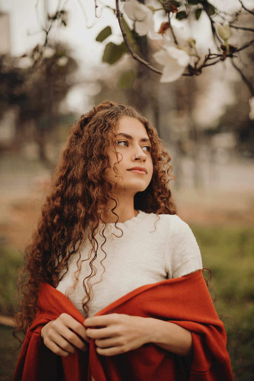 a woman with curly hair wearing a red cape