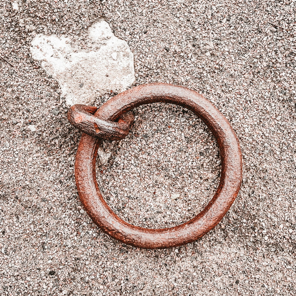 a rusted metal ring laying on the ground