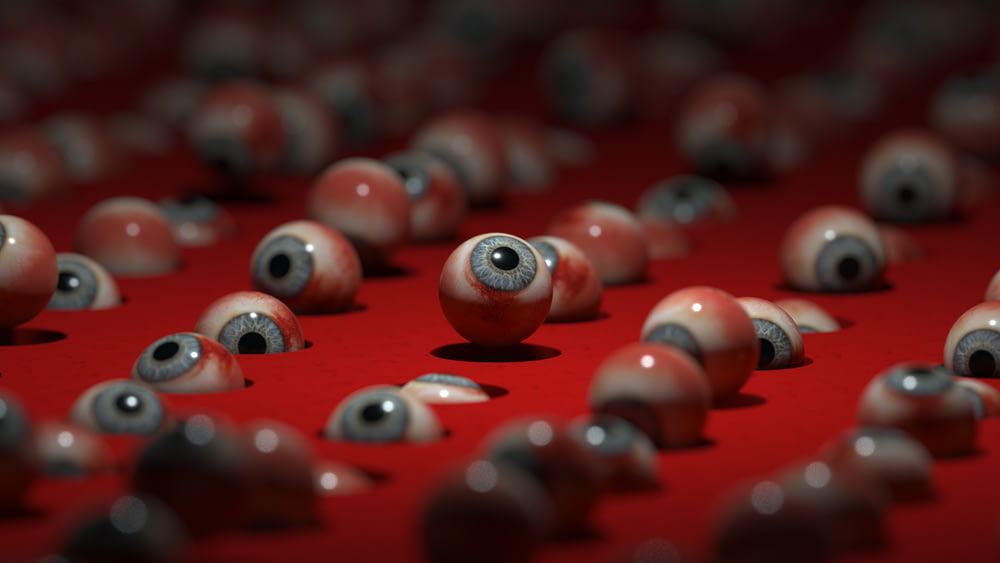 a group of red balls with black and white eyes