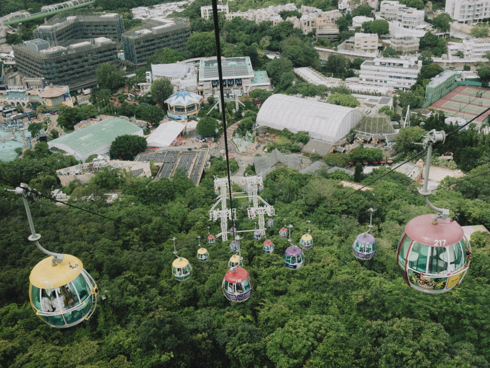 an aerial view of a carnival ride in the middle of a forest