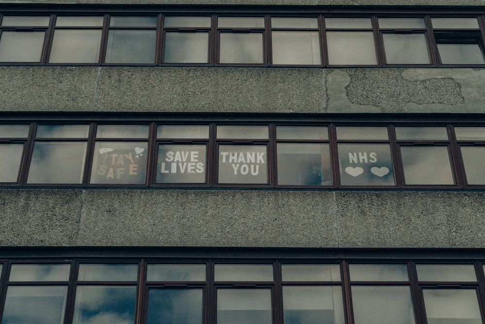 the windows of a building with some signs on them