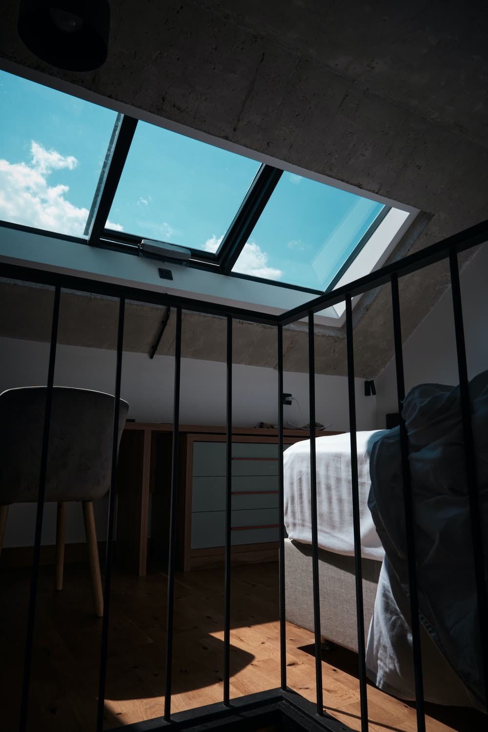a bedroom with a bed and a skylight