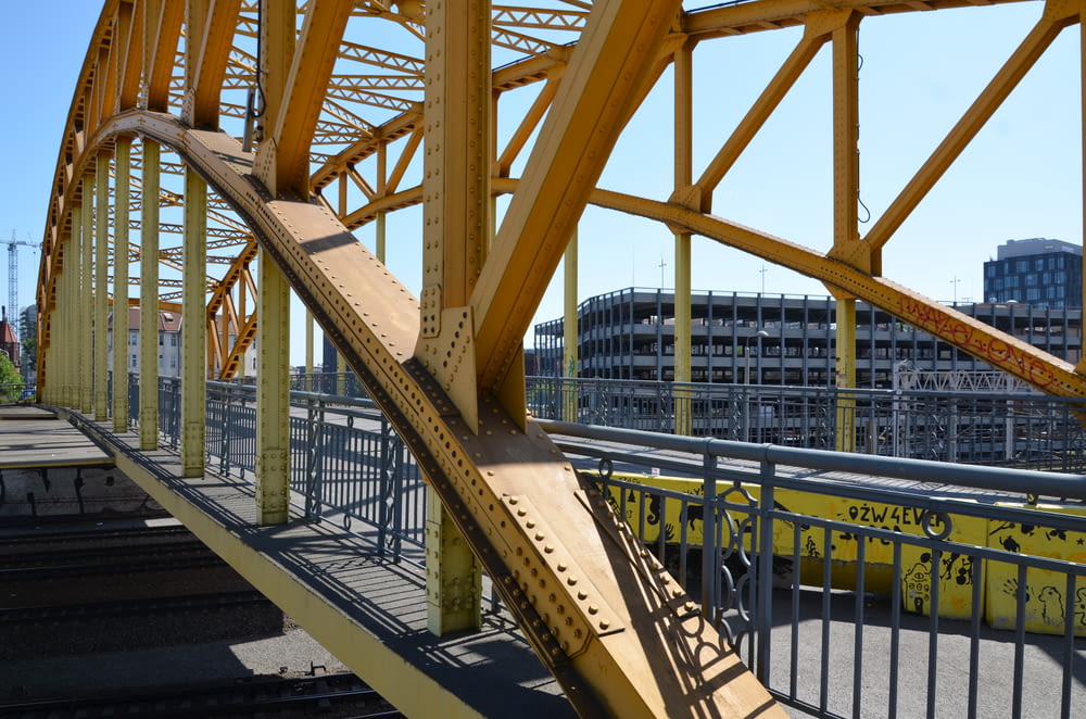 a train track going over a yellow bridge