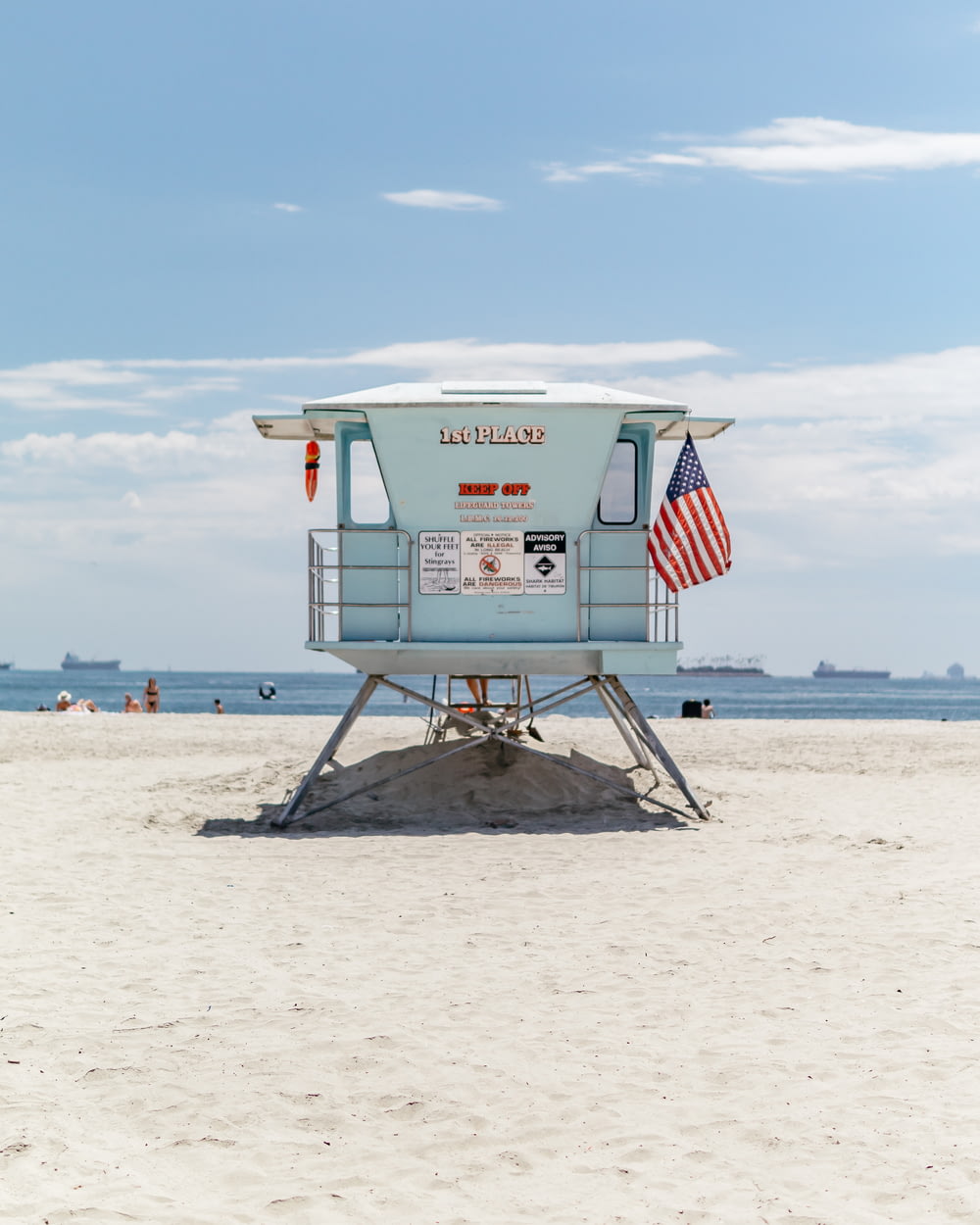 a lifeguard stand on the beach with an american flag
