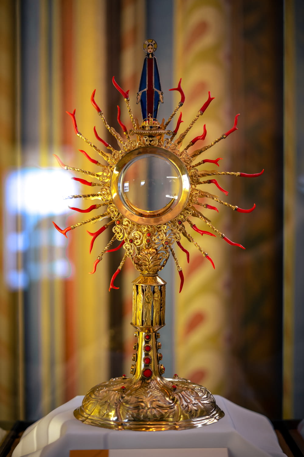 a golden clock with a mirror on top of it