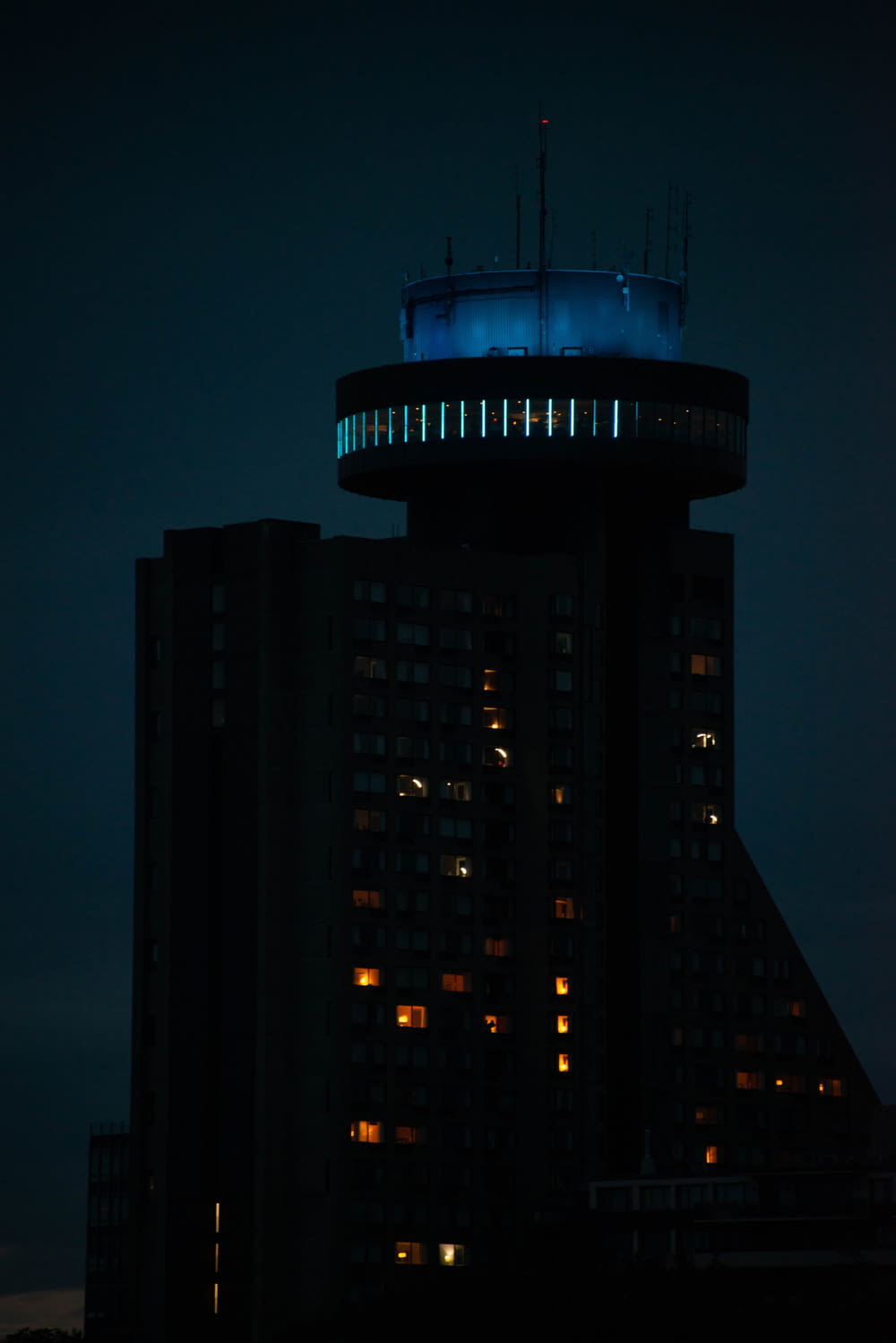 a tall building with a tower lit up at night