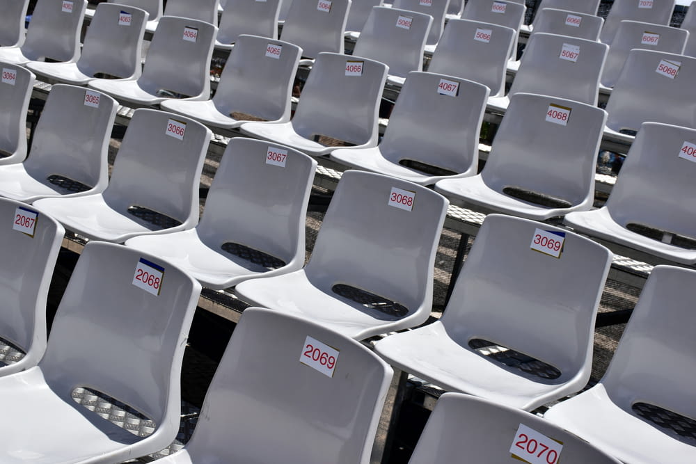 a row of white chairs with a price label on them