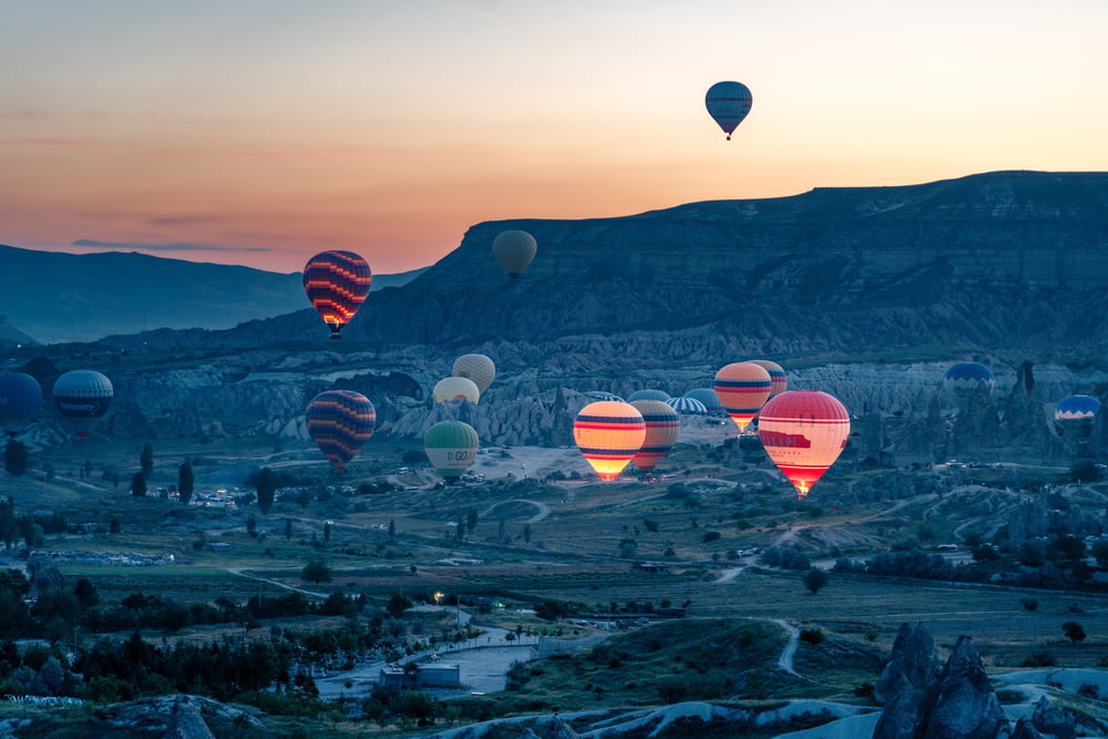 a number of hot air balloons flying in the sky