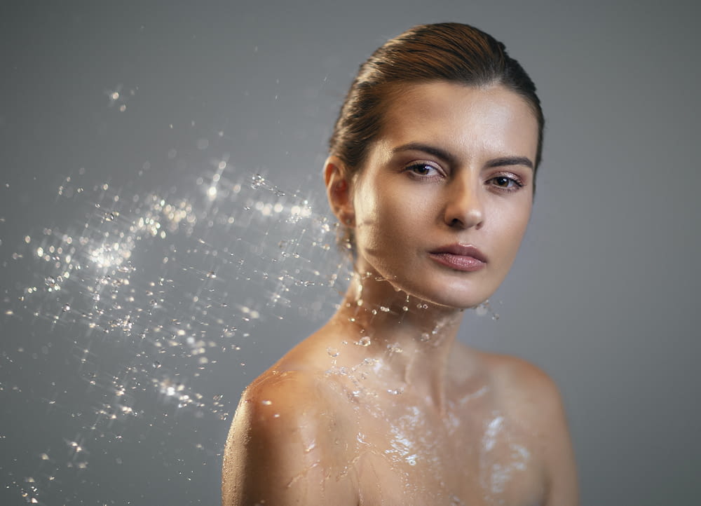 a woman with bubbles of water on her face