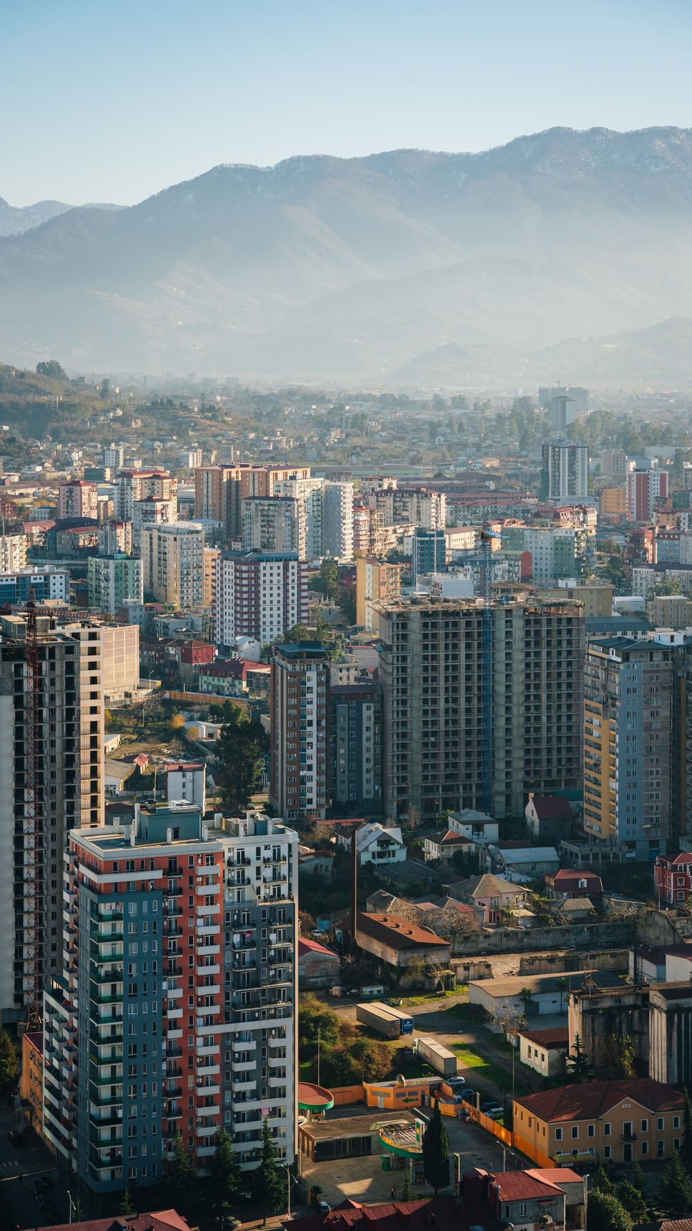 a city with tall buildings and mountains in the background