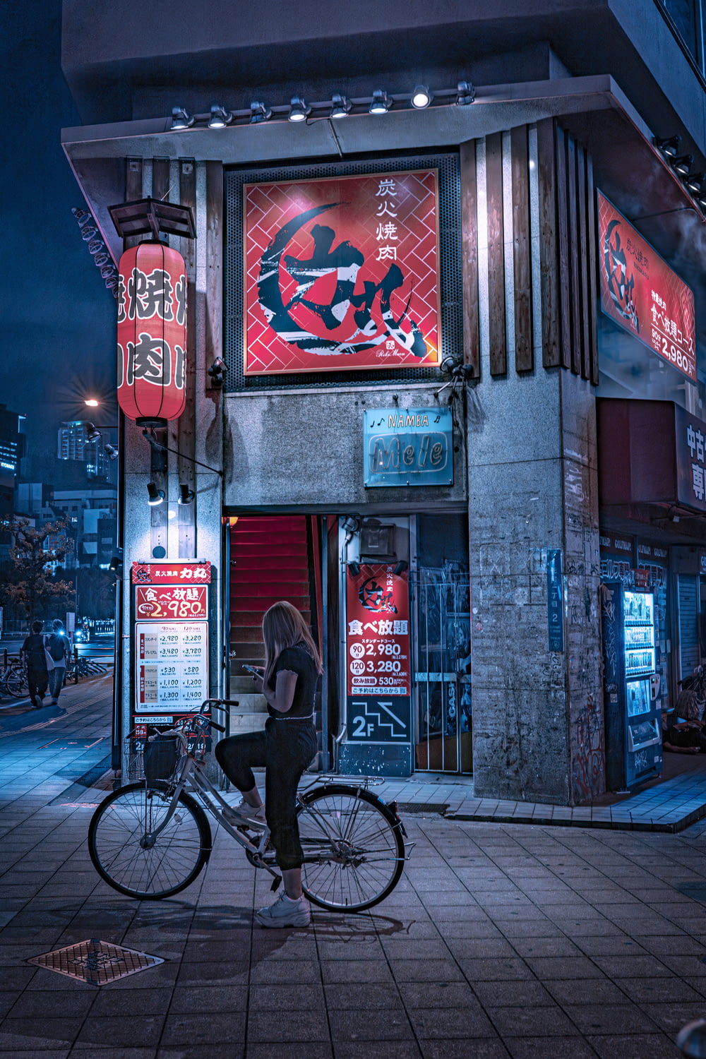 a woman sitting on a bike in front of a building