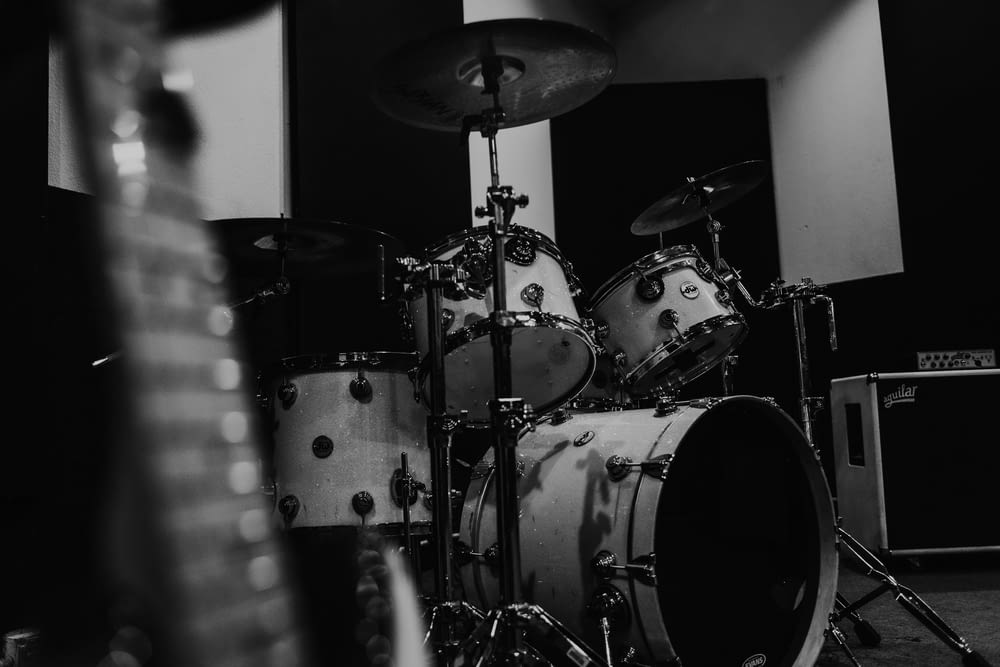 a black and white photo of a drum set