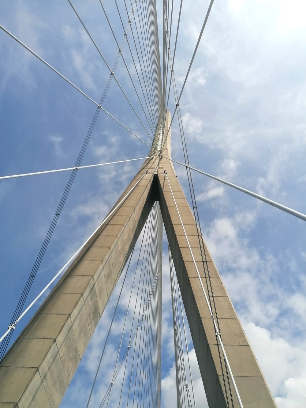 looking up at the top of a tall bridge