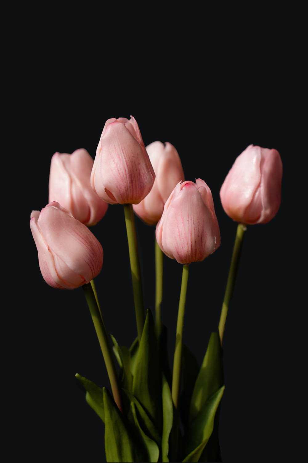 a bunch of pink tulips in a vase