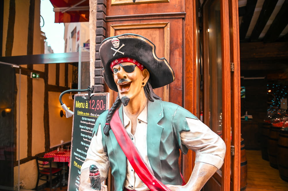 a statue of a pirate holding a bottle of booze
