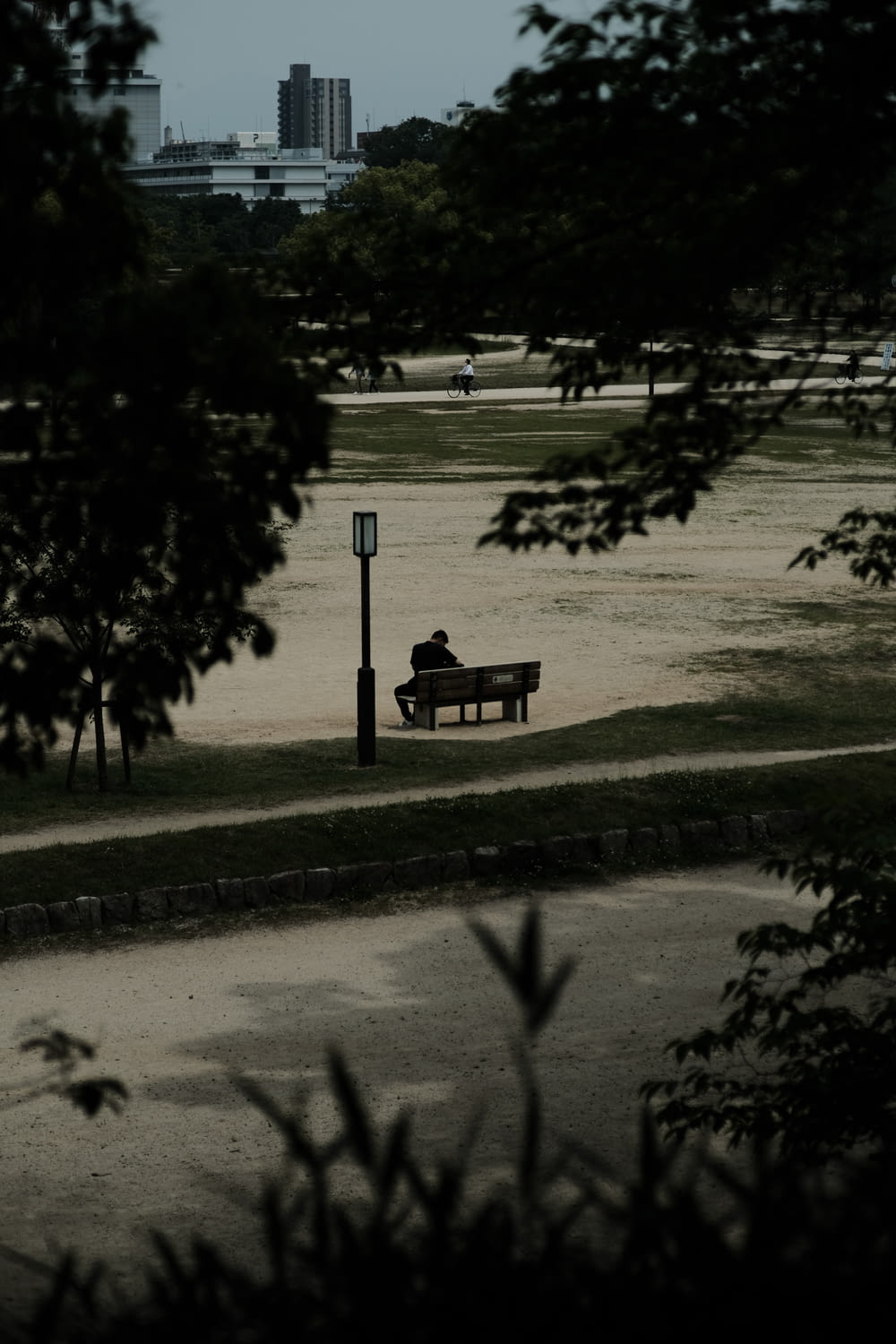 a couple sitting on a bench in a park