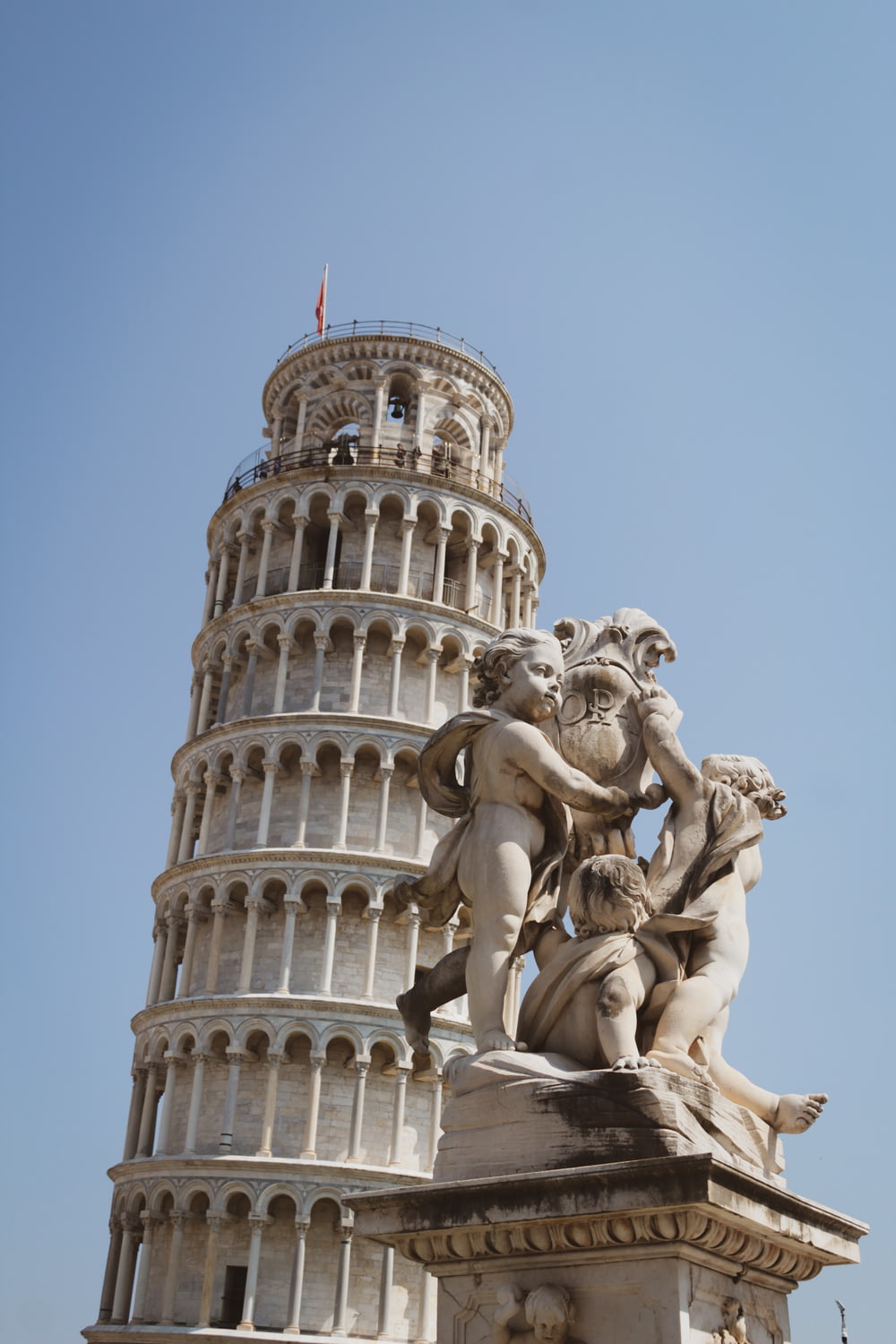 a tall tower with a statue on top of it