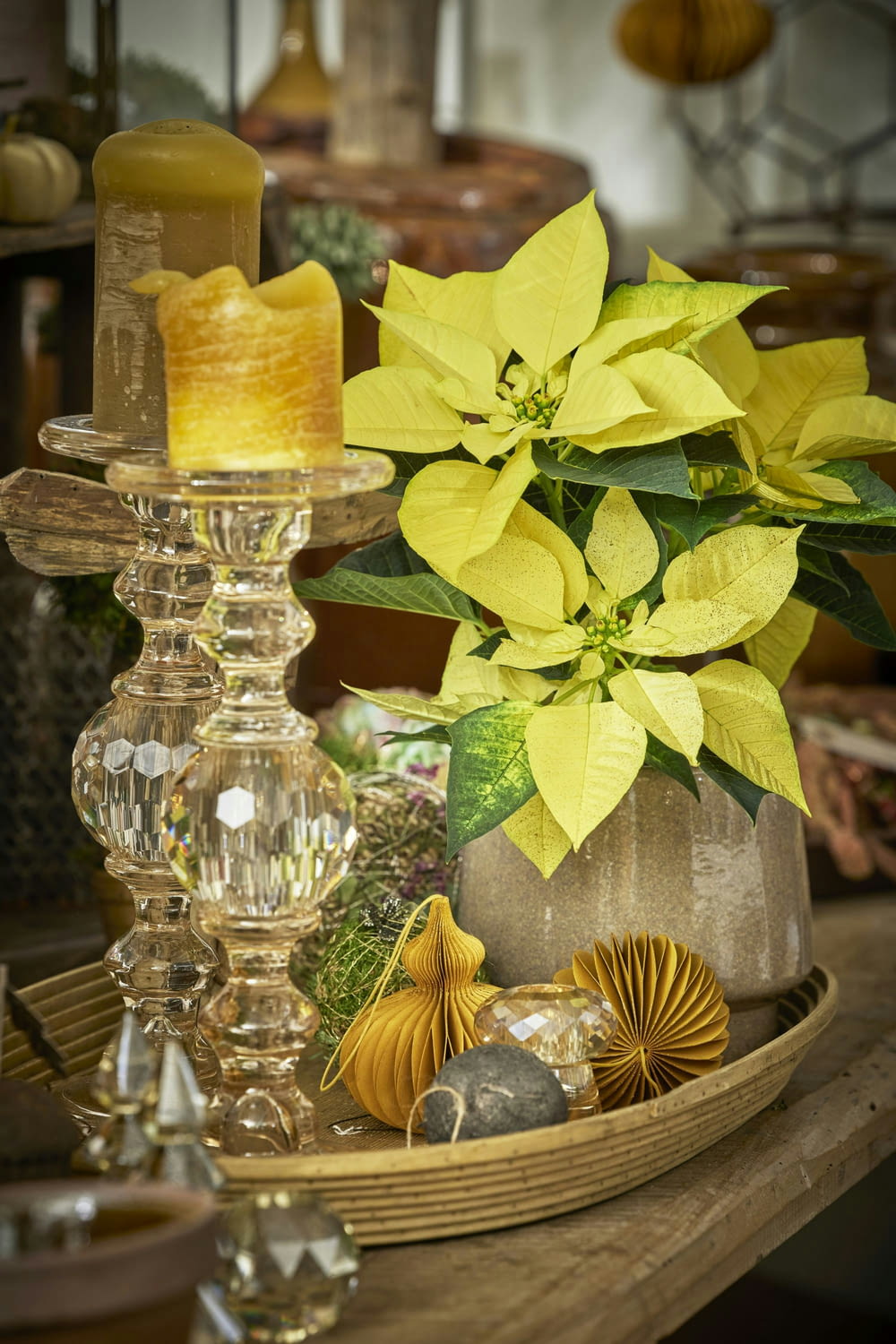 a table topped with a vase filled with yellow flowers