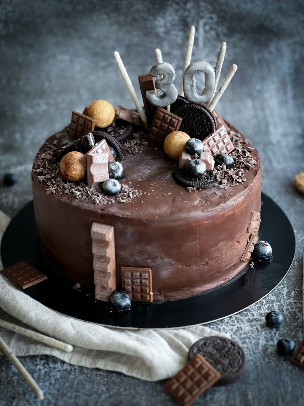 a chocolate cake decorated with chocolate candies and marshmallows