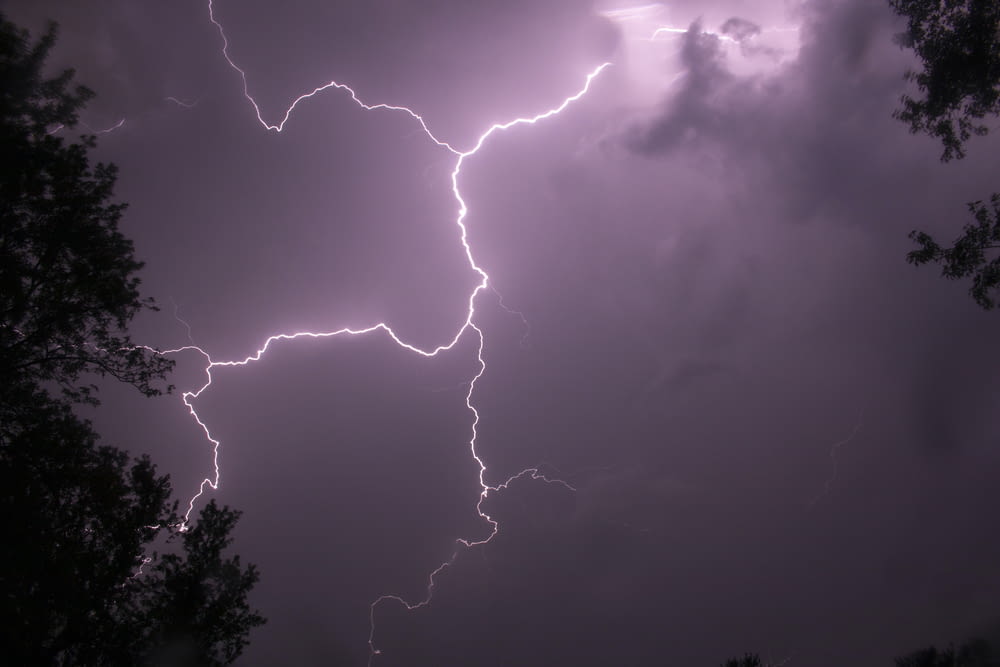 a lightning bolt hitting through a cloudy sky