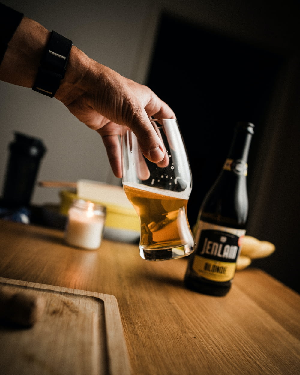 a person is pouring a beer into a glass